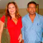 Três pessoas posam nesta foto em cores. Observa-se que o homem, à direita, demonstra feição séria, enquanto as mulheres sorriem.