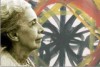 MOSTRA NISE DA SILVEIRA: VIDA E OBRA. Descrio da imagem: A fotografia revela a psiquiatra Nise da Silveira de perfil, em primeirssimo plano. Ao fundo v-se a pintura de uma mandala, forma circular, oriunda das oficinas teraputicas do Instituto Municipal Nise da Silveira. Fim da descrio.